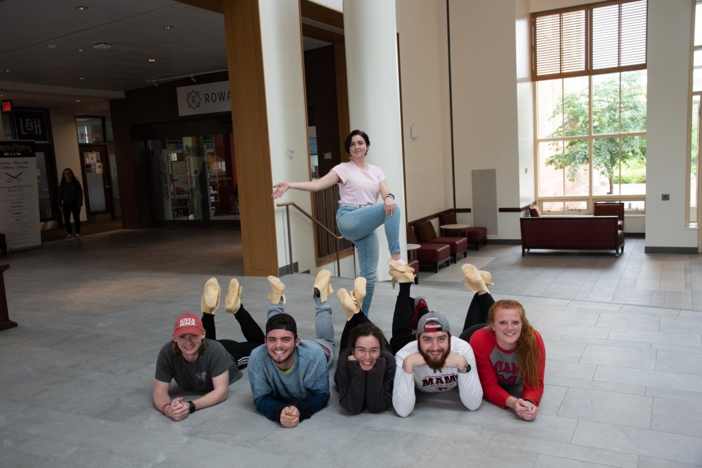 Myaamia Heritage Students posing with moccasins they made at a workshop.