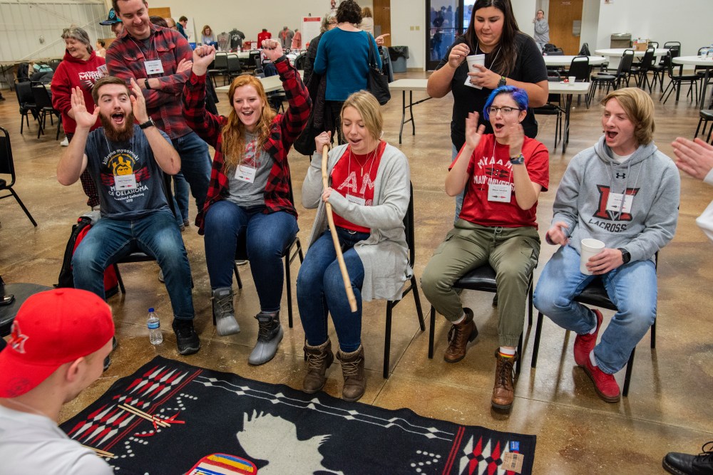 Myaamia Heritage Students playing mahkisina meehkintiinki 'moccasin game' at the Miami Tribe's 2019 Winter Gathering.