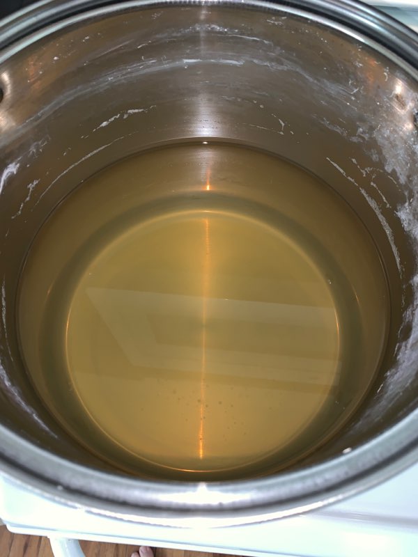 Golden sap in a pot created during the maple sap boiling process