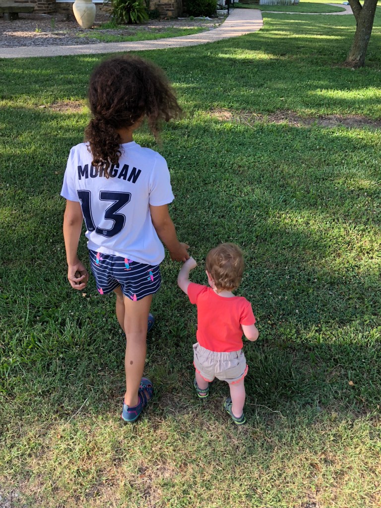 Seenseewia walking with one of her Myaamia cousins.