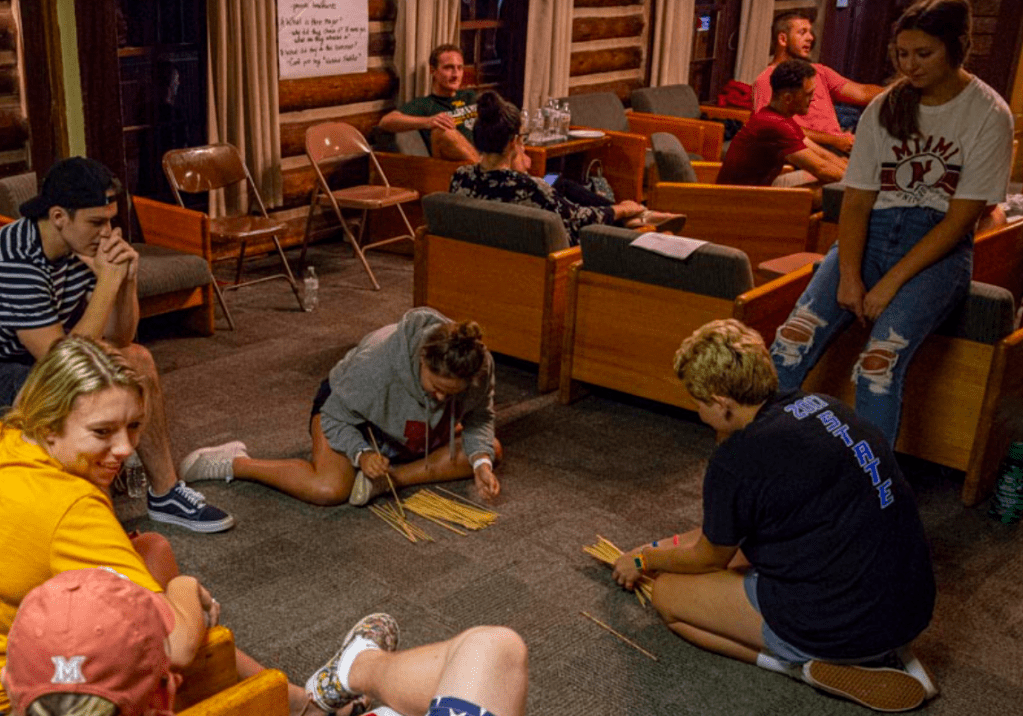 College students gathered on the floor with straws for the game