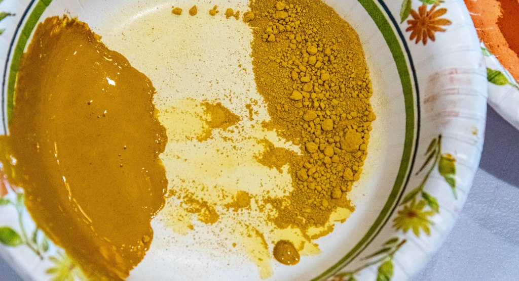 Yellow tempera pigment on the left and yellow ochre on the right of a bowl