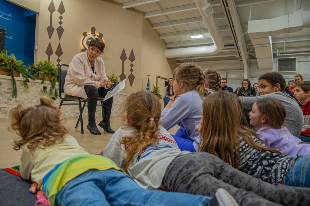 Woman telling a story to young listeners
