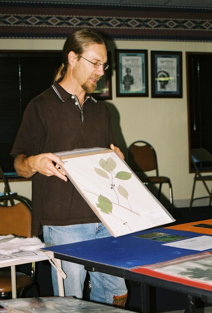 Man holding a mounted plant example