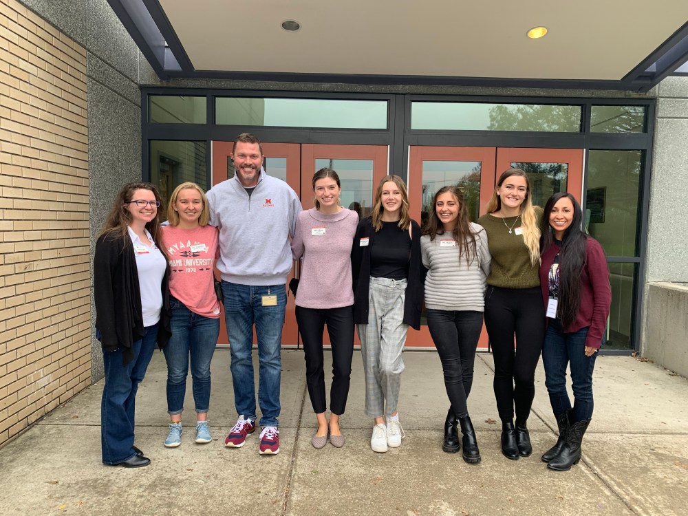 A group of people in front of a school