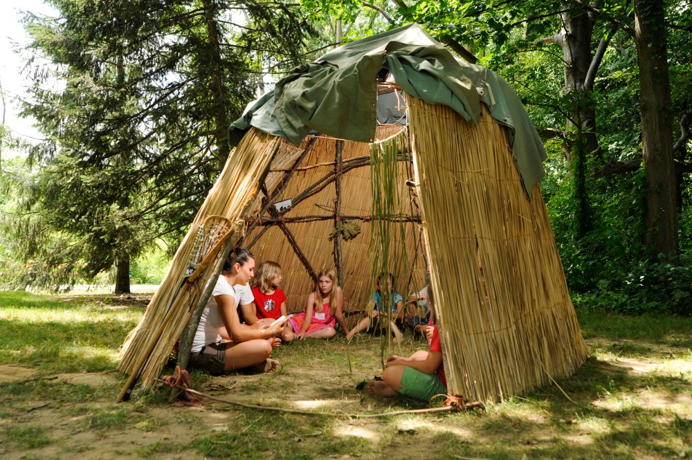 A group of people sitting in a wigwam