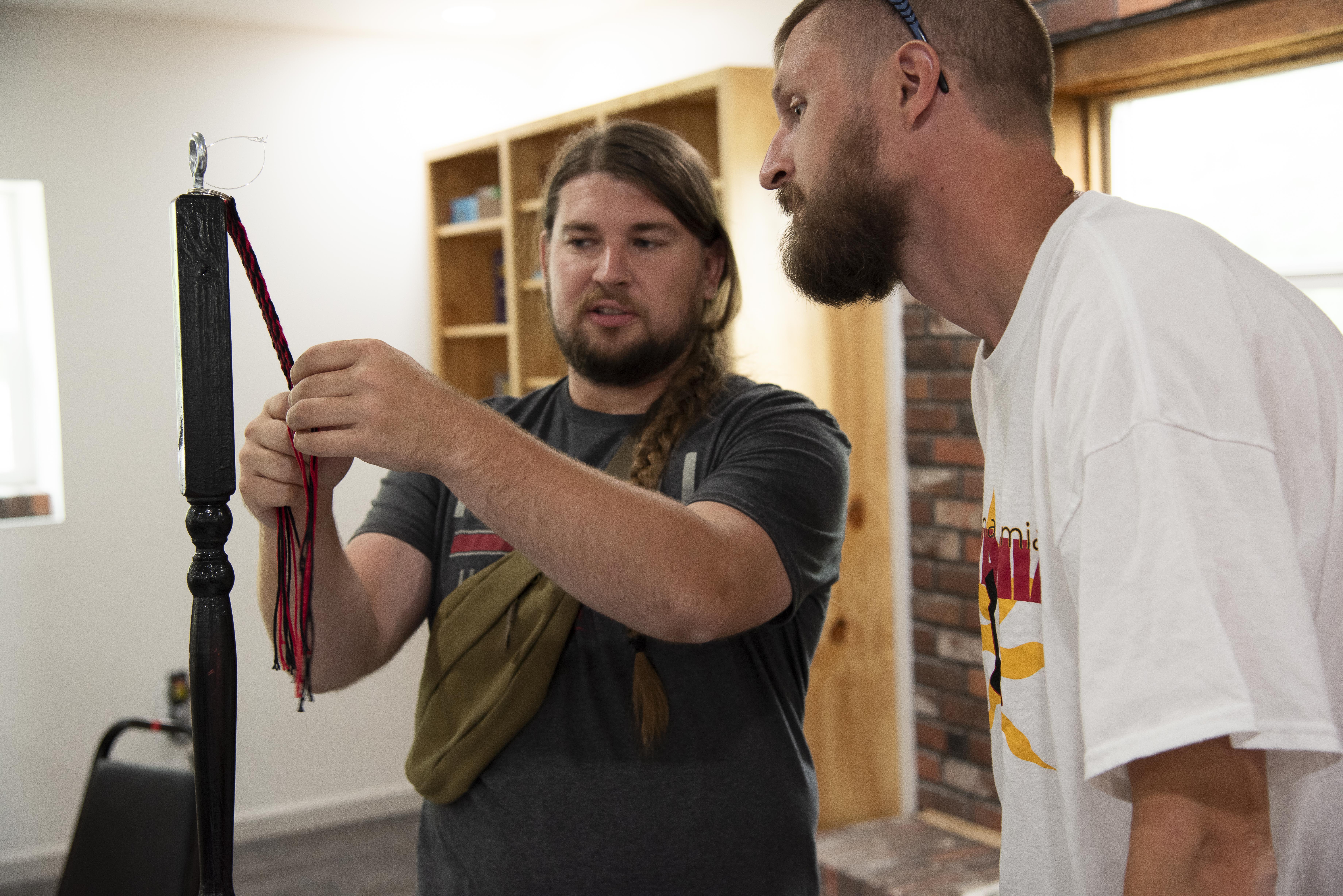 Two men working on a keychain