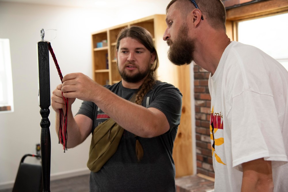 Two men working on a keychain