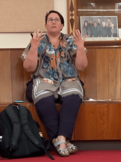 Woman gesticulating with a presentation clicker