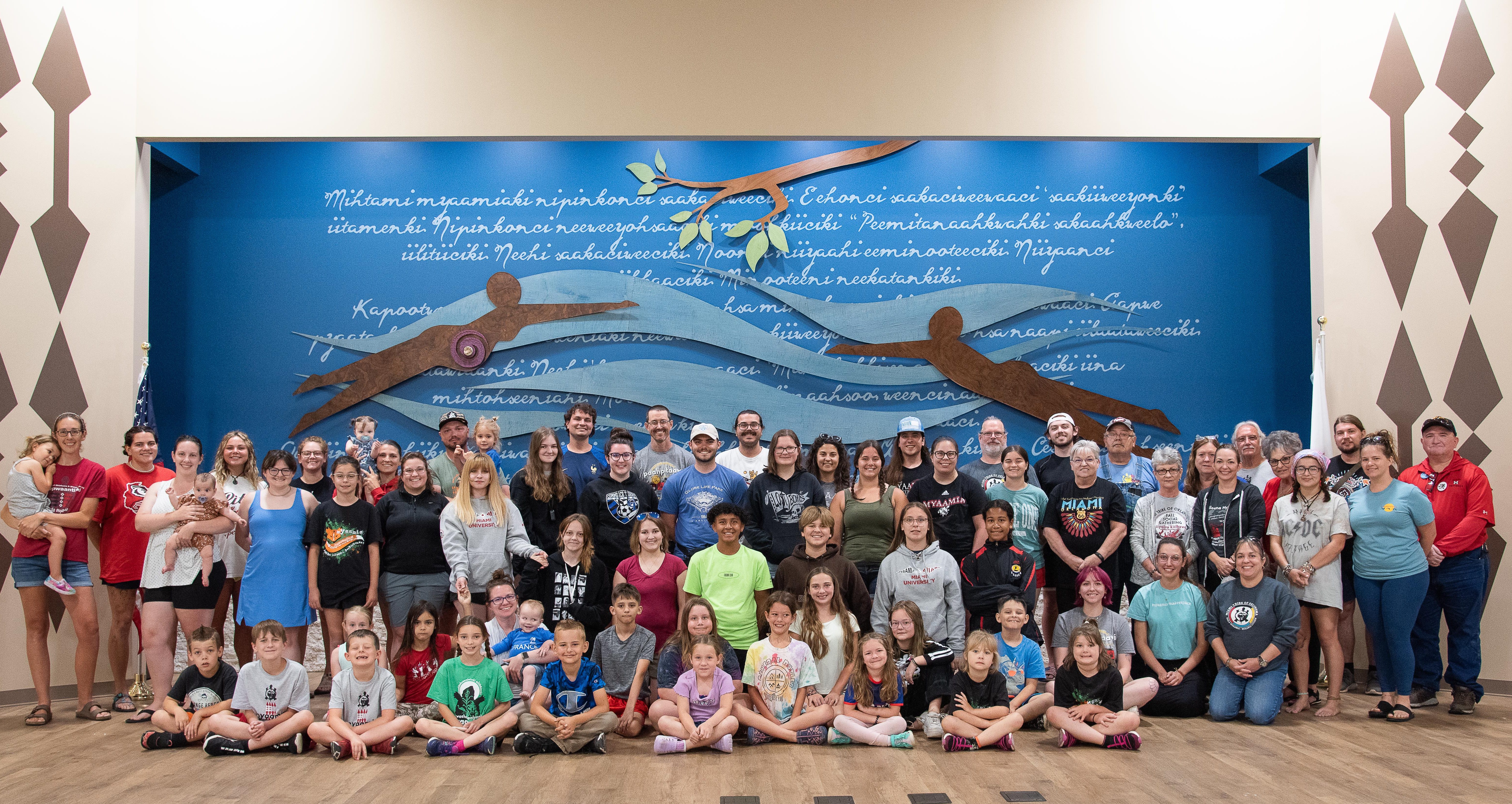 A group of about 60 people pose for a photo in the Miami Tribe's council house
