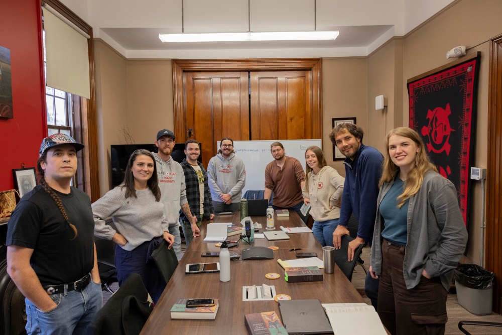 The group stands in the conference room of the Myaamia Center for a group photo