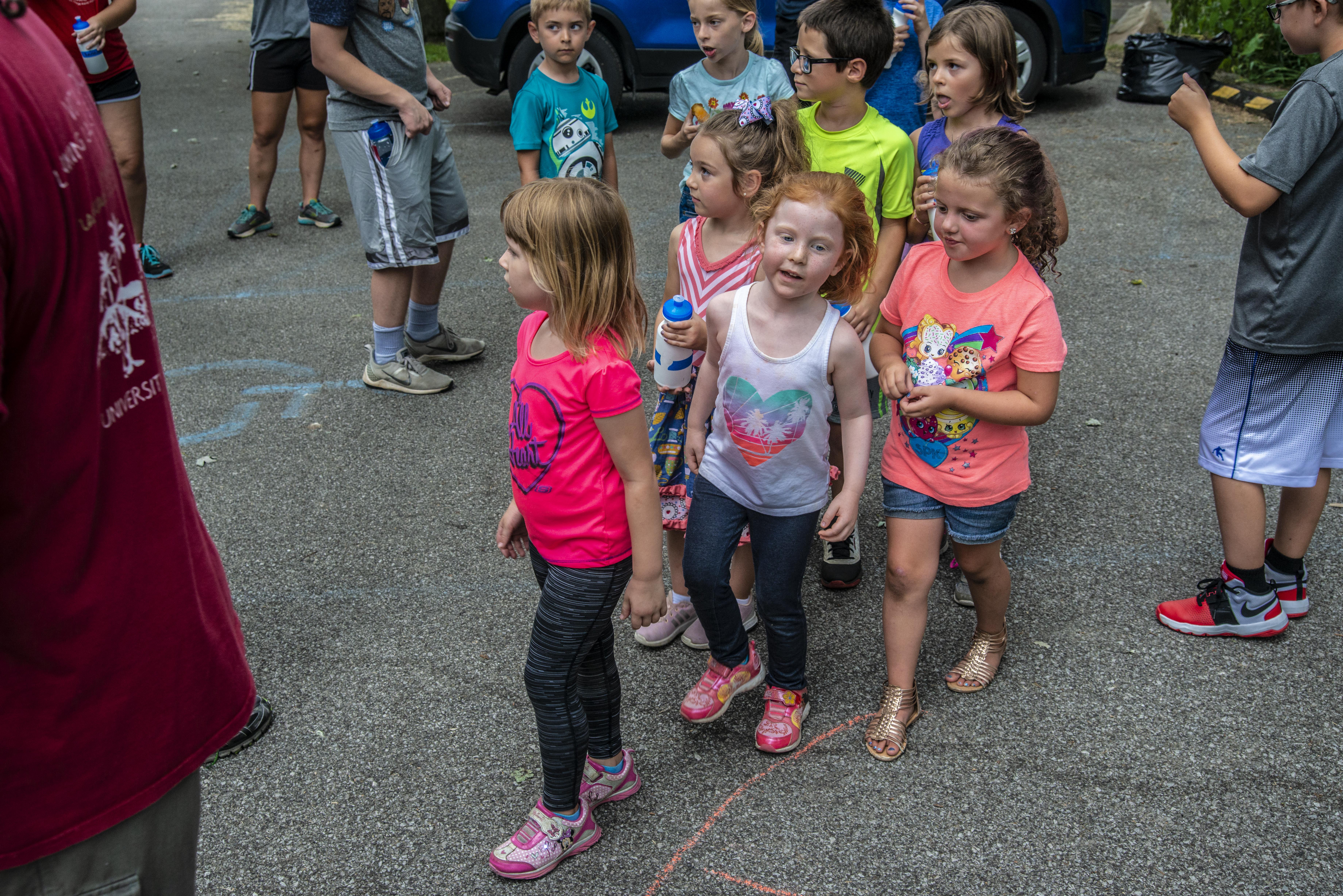 A group of small children line up to dance