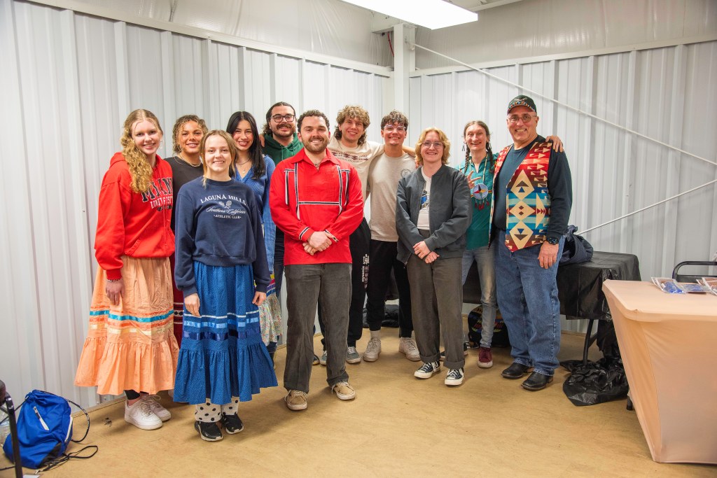 a group of Myaamia students and Chief Lankford smiling at Winter Gathering.