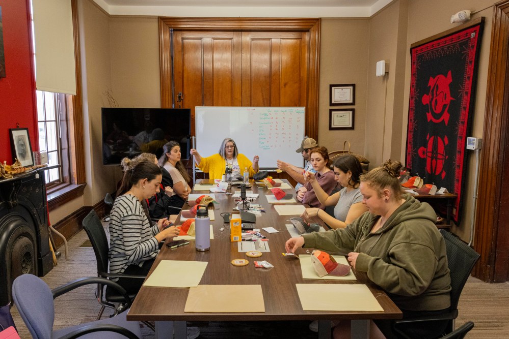 8 people sit around a long conference table at the Myaamia Center