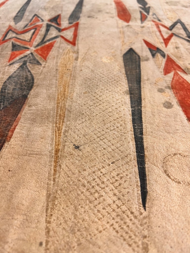 Black, yellow, and red patterns against the tan hide