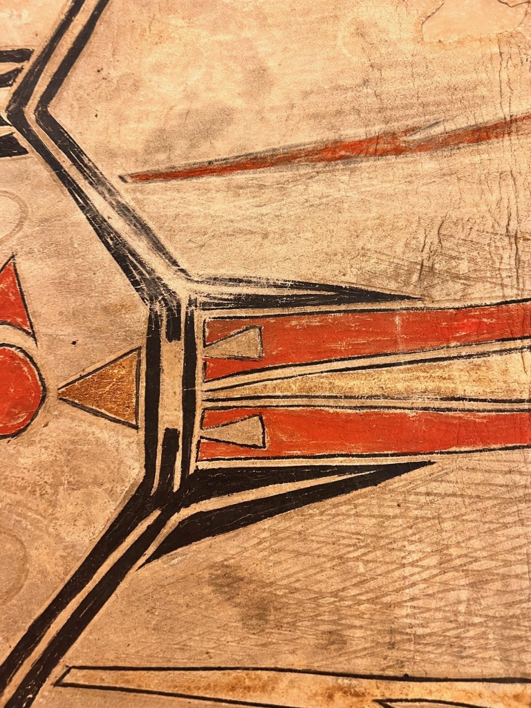 Black, yellow, and red patterns against the tan hide