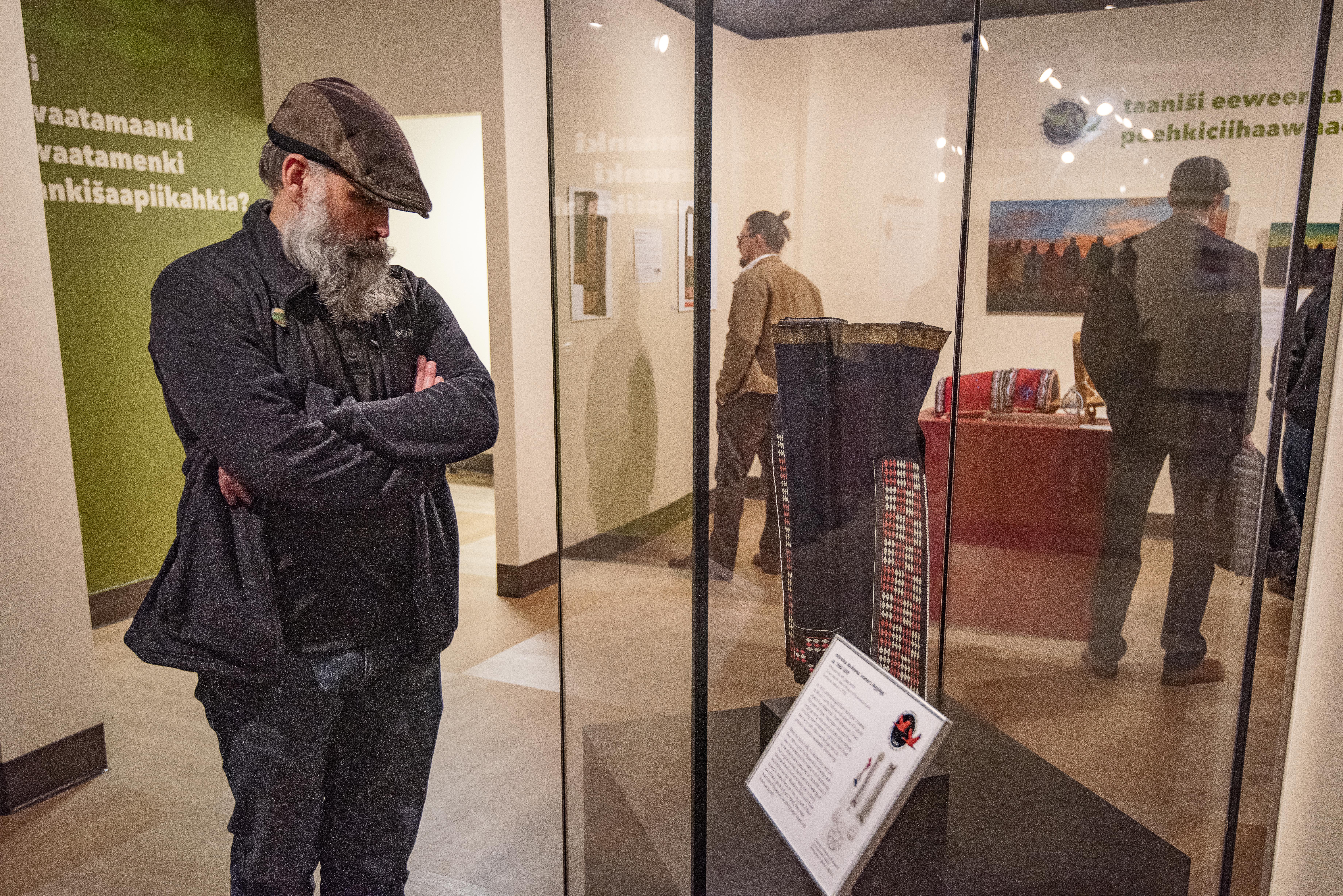A person reads about an item in a display case