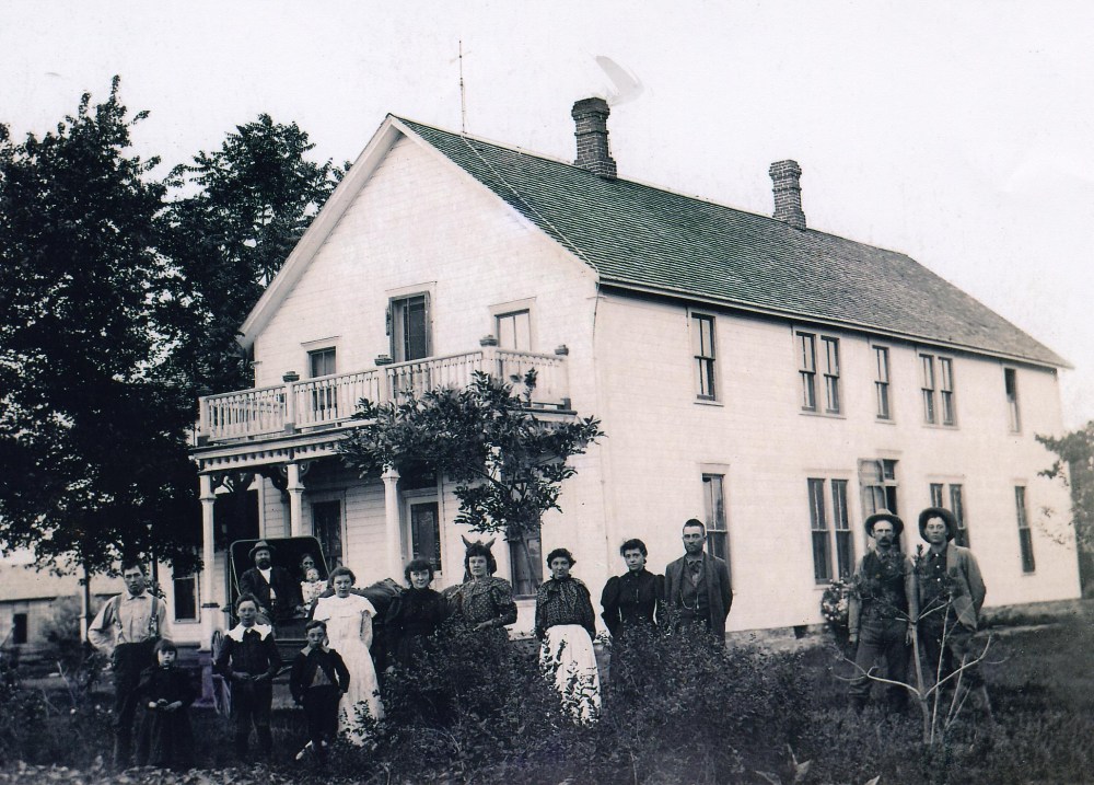Drake family stands outside their family home