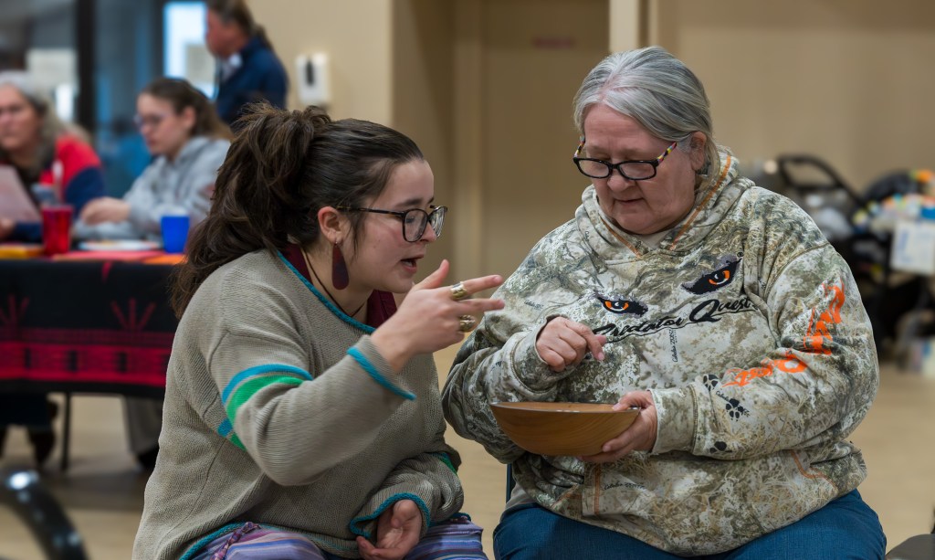 Two women play bowl game